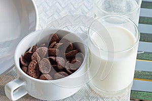 Glass of milk and Chocolate cereal for breakfast.