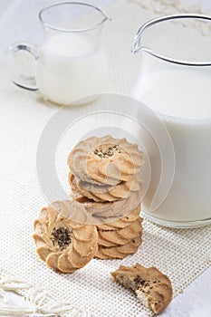 Glass of milk and cookies isolated on white