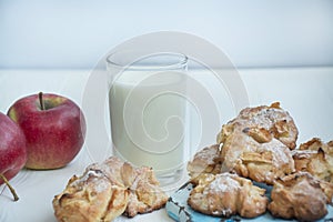 A glass of milk with homemade apple cookies. Cookies with apples. A glass of warm milk. Copy space. Dinner table. Healthy food