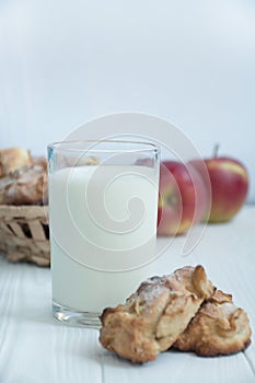 A glass of milk with homemade apple cookies. Cookies with apples. A glass of warm milk. Copy space. Dinner table. Healthy food