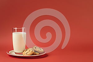 Glass milk plate cookies marsala background. Snack concept. Festive dessert option. Copy space