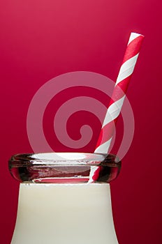 Glass of milk on red background