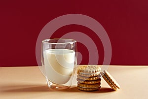 Glass of milk and round homemade cookies