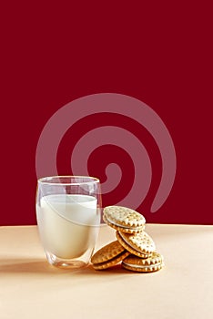 Glass of milk and round homemade cookies