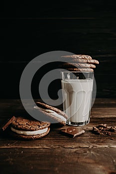 a glass of milk on the table, cookies m chocolate next