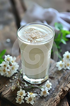 Glass of milk on a table with fresh mint. Close-up photography with blurred background