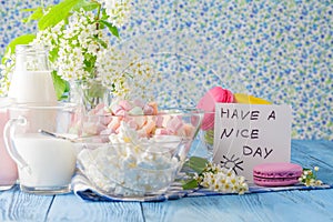 Glass of milk with Tasty macaroon on with background