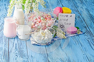 Glass of milk with Tasty macaroon on with background