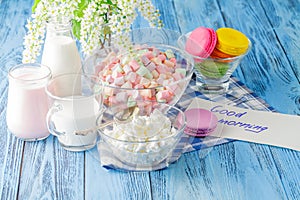 Glass of milk with Tasty macaroon on with background