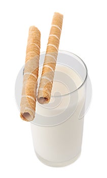 Glass of milk and wafel sticks isolated over the white background