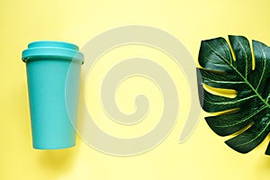 Glass mint color on a yellow background with plant