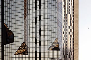 A glass modern building with geometric angles and reflection