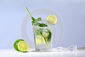 Glass with mojito cocktail and limes