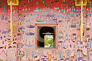 Glass mosaic at wat xieng thong temple wall, Laos photo
