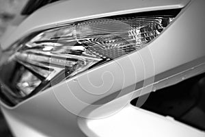 Glass motorcycle headlight. Graceful lines. Black and white