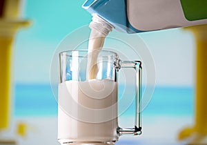 Glass mug with coconut milk and milk carton