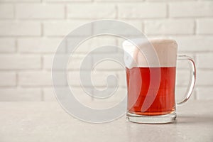 Glass mug with cold red beer