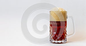 Glass mug full of a red beer with a foam cap