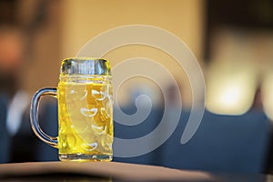 Glass mug of golden light beer in bar, in pub close up. Real scene. Beer culture, Craft brewery, uniqueness of beer