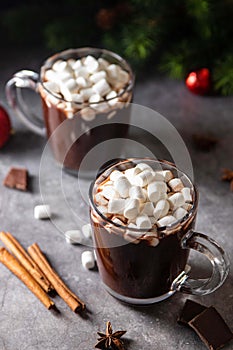 Glass mug with hot chocolate cocoa drink with marshmallow. Copy space. Dark background. Winter, Christmas and New Year drink.