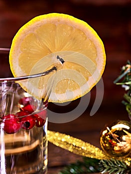 Glass mug with slice lemon and Christmas ball .