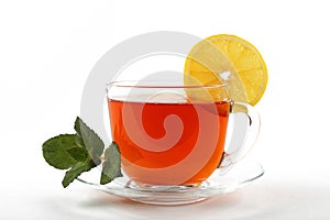 glass mug of tea with mint leaves and lemon