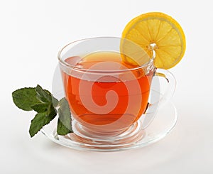 glass mug of tea with mint leaves and lemon