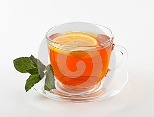 glass mug of tea with mint leaves and lemon