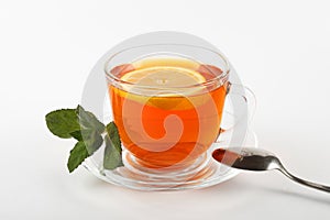 glass mug of tea with mint leaves and lemon