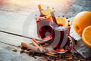 Glass mugs of mulled wine with spices and citrus fruits