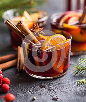 Glass mugs of mulled wine with spices and citrus fruits. Traditional hot drink or beverage, festive cocktail at X-mas or New Year