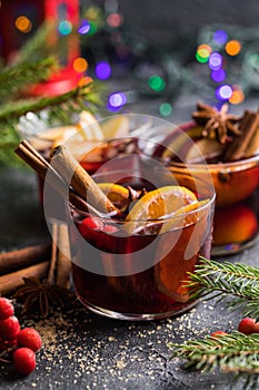 Glass mugs of mulled wine with spices and citrus fruits. Traditional hot drink or beverage, festive cocktail at X-mas or New Year