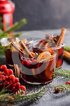 Glass mugs of mulled wine with spices and citrus fruits. Traditional hot drink or beverage, festive cocktail at X-mas or New Year