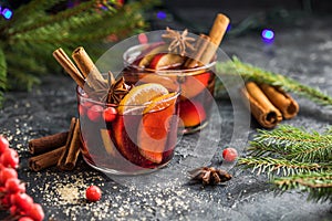 Glass mugs of mulled wine with spices and citrus fruits. Traditional hot drink or beverage, festive cocktail at X-mas or New Year