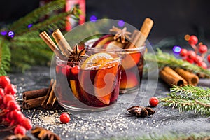 Glass mugs of mulled wine with spices and citrus fruits. Traditional hot drink or beverage, festive cocktail at X-mas or New Year