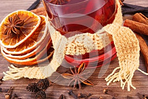 Glass of mulled wine wrapped scarf with fresh fragrant spices