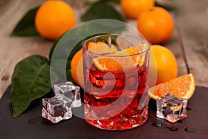 A glass of Negroni cocktail with Campari, Vermouth, Gin and Oranges.