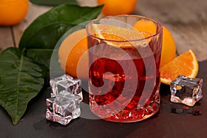 A glass of Negroni cocktail with Campari, Vermouth, Gin and Oranges.