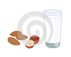 Glass of nutty vegetarian milk, alongside almonds and hazelnuts