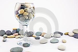 Glass with ocean rocks on white background