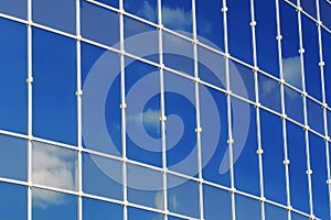 Glass office building reflection sky cloud