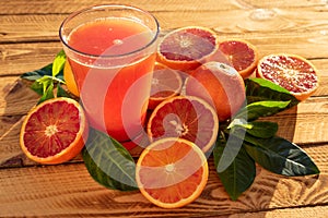 Glass With Orange Juice Of Blood Oranges With Fresh Fruits. Outdoor Shot In The Sunshine