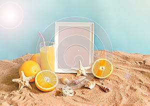 Glass of orange juice, frame, starfishes and seashells on sand beach