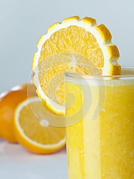 A glass of orange Juice with fruits