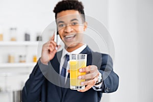 Glass of orange juice in hand