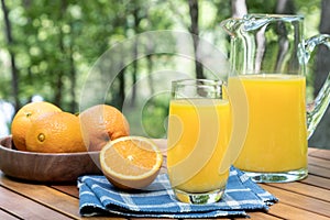 Glass of orange juice outdoors on a table