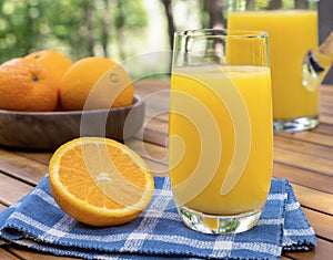Glass of orange juice outdoors on a table