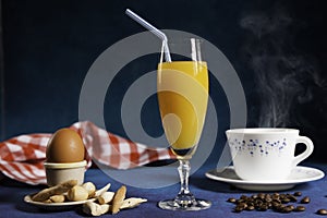 Glass of orange juice and steaming cup of coffee