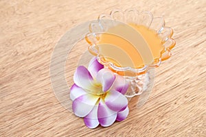 Glass of orange juice on wooden background