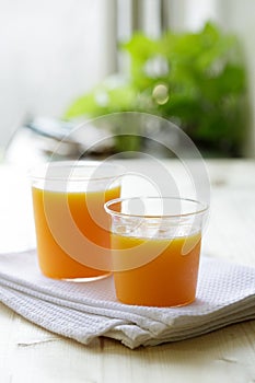 Glass of orange juice on a wooden table. Fresh orange juice